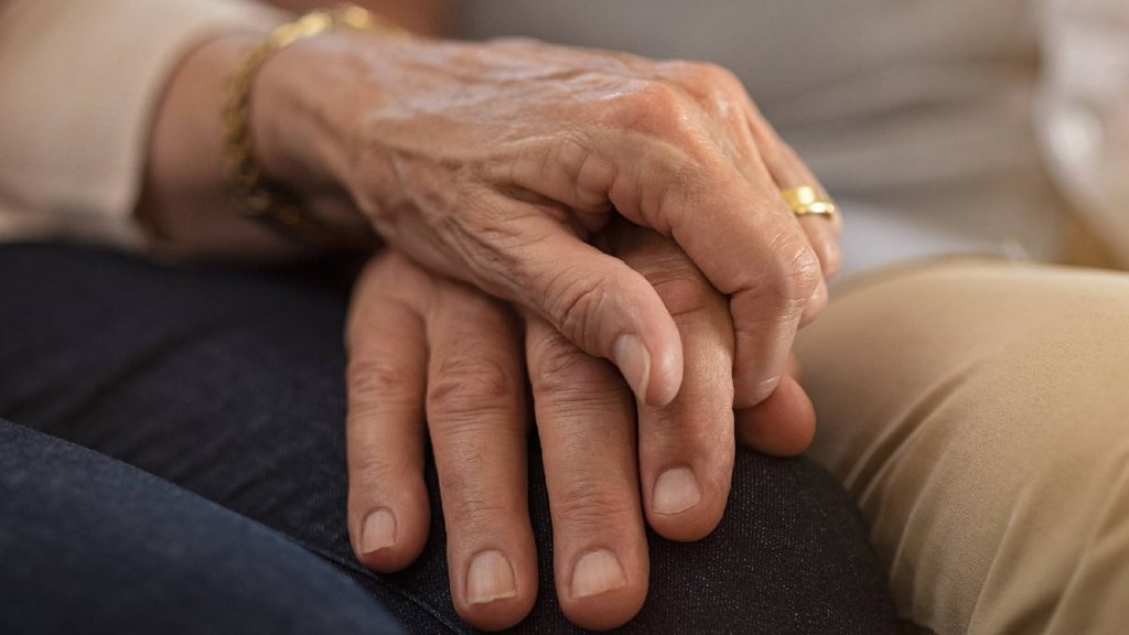 Idosos de mãos dadas provando que têm um relacionamento duradouro