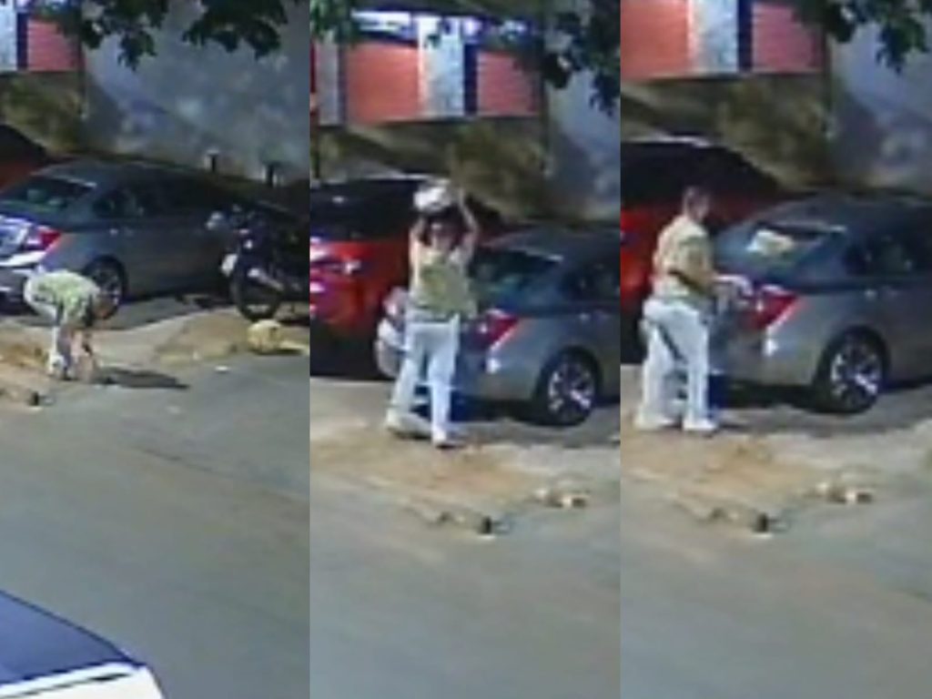 Câmeras registraram o momento em que indivíduo joga pedaço de concreto no carro. (Foto: Reprodução)