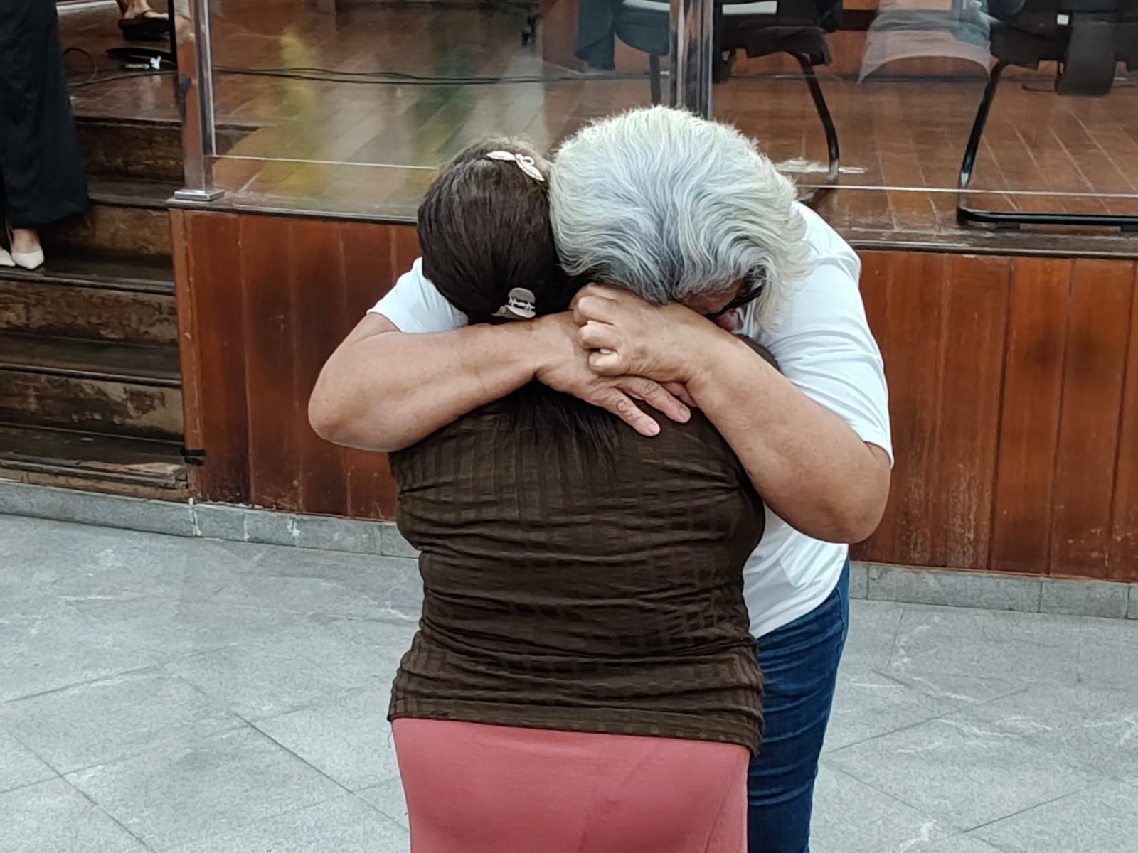 Mães da vítima e da ré se abraçaram após leitura da sentença. (Foto: Davi Galvão)