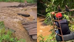Ponte foi arrastada pela chuva, e moradores agora precisam se arriscar com tirolesa para cruzar o Rio do Peixe.