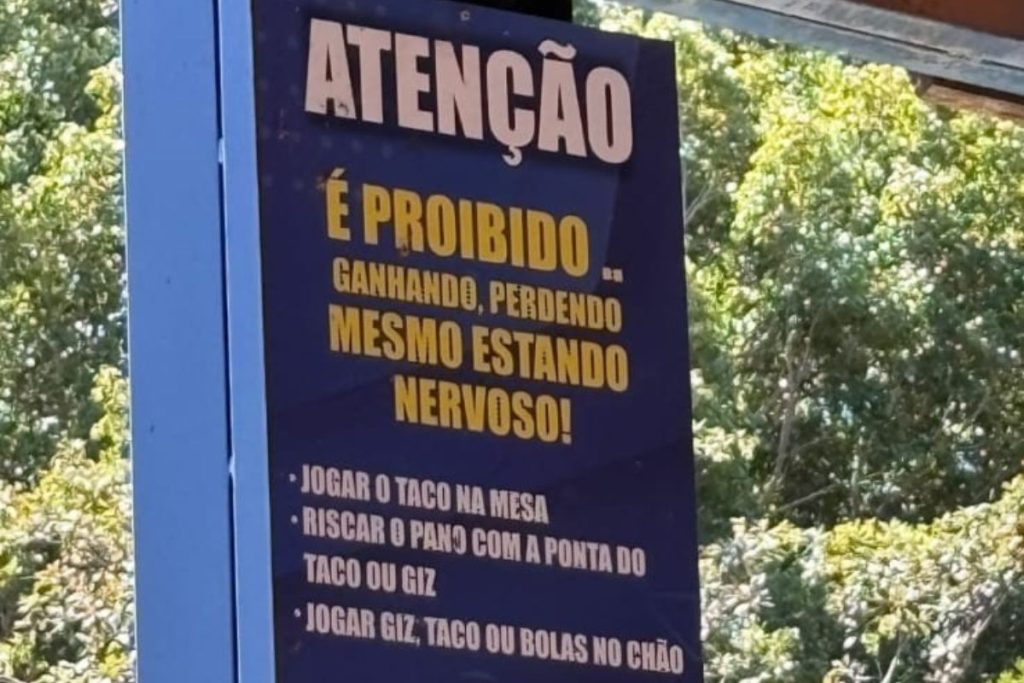 Placa curiosa em clube de Goiás viraliza ao proibir ataques de fúria em mesa de sinuca