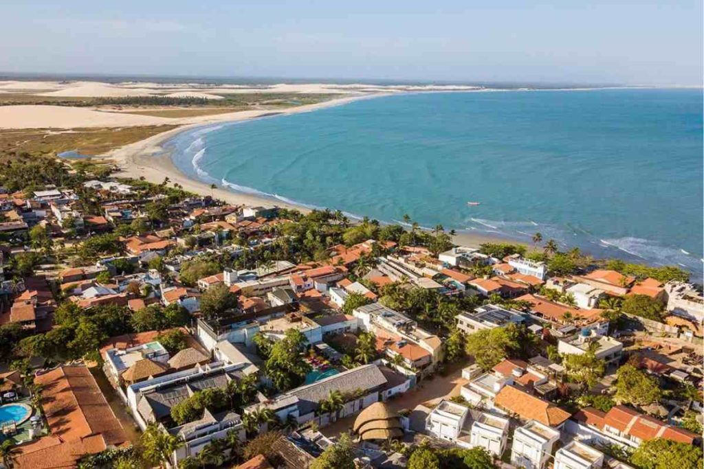 Vista de Jericoacoara, no Ceará, com ruas de areia, casas simples e paisagem litorânea preservada e praia linda