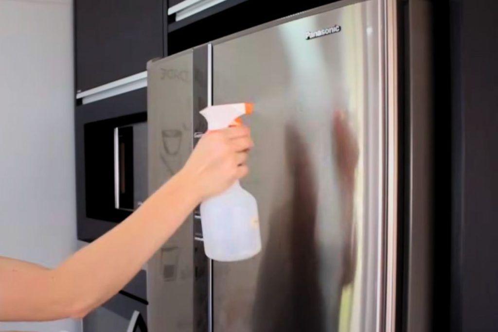 Geladeira de inox sendo limpa
